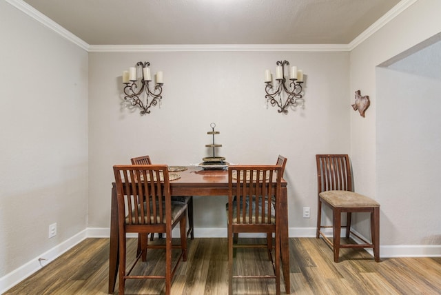 dining space with crown molding and hardwood / wood-style flooring