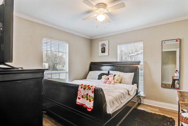 bedroom featuring ceiling fan, hardwood / wood-style floors, and ornamental molding