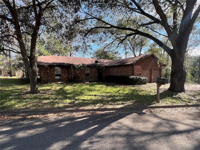 view of front facade with a front yard and a garage