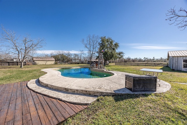 view of pool featuring a yard and a wooden deck