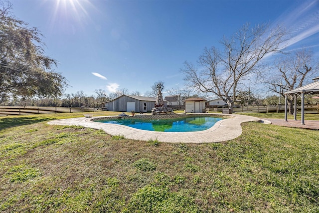 view of swimming pool with a gazebo, a shed, and a lawn