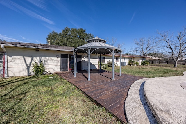 exterior space featuring a gazebo, a lawn, and a deck