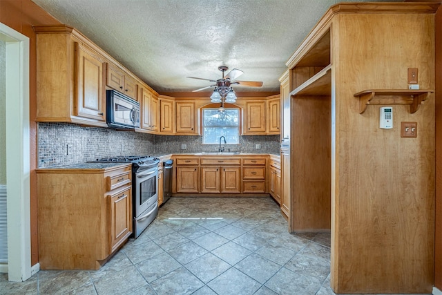 kitchen featuring decorative backsplash, ceiling fan, sink, and appliances with stainless steel finishes