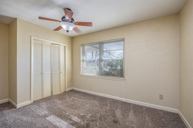 unfurnished bedroom featuring ceiling fan, a closet, and carpet floors