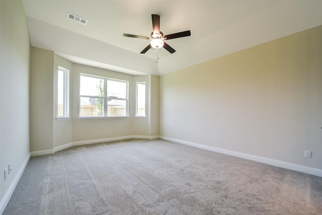 unfurnished room with carpet flooring, a ceiling fan, and baseboards