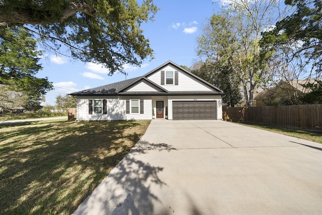 view of front of house featuring a garage and a front lawn