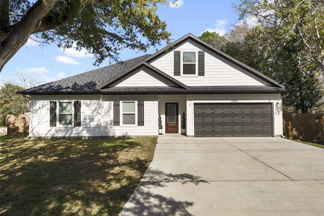 view of front of property featuring a garage and a front lawn