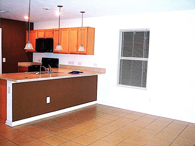 kitchen with sink, light tile patterned flooring, and decorative light fixtures