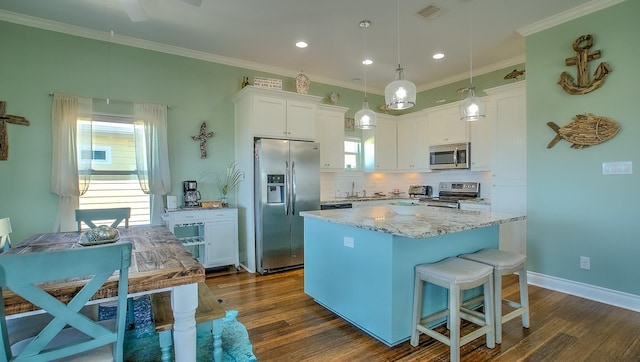 kitchen with dark hardwood / wood-style floors, white cabinetry, stainless steel appliances, and hanging light fixtures