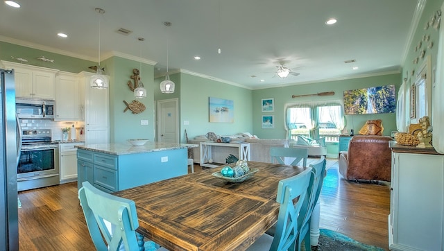 dining room featuring ceiling fan, dark hardwood / wood-style flooring, and ornamental molding