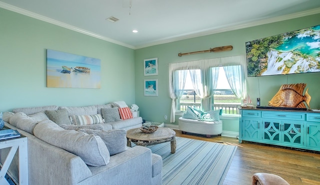 living room with light hardwood / wood-style floors and ornamental molding