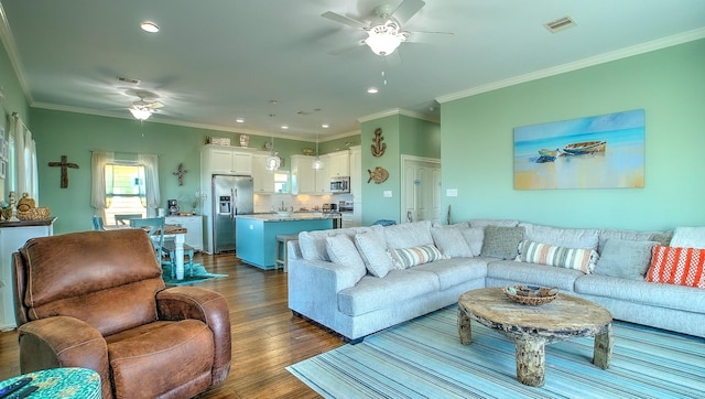 living room featuring dark hardwood / wood-style floors, ceiling fan, and crown molding