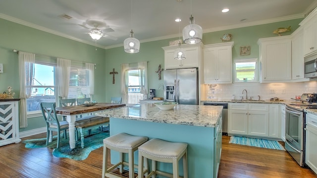 kitchen with white cabinets, a center island, and stainless steel appliances