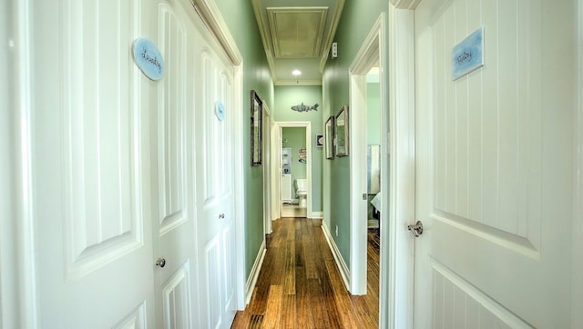 hall featuring ornamental molding and dark wood-type flooring