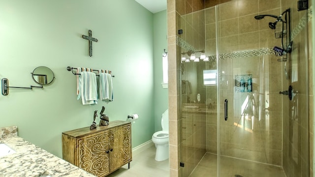 bathroom featuring tile patterned flooring, vanity, toilet, and an enclosed shower