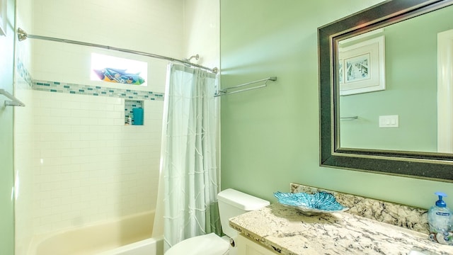 full bathroom featuring vanity, shower / bath combination with curtain, and toilet