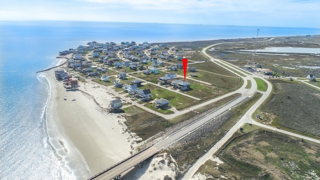 bird's eye view featuring a water view and a beach view