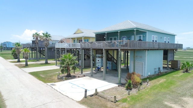 exterior space featuring a balcony, a garage, and a carport