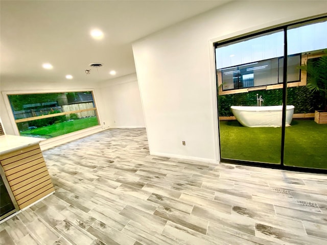 unfurnished living room with hardwood / wood-style floors