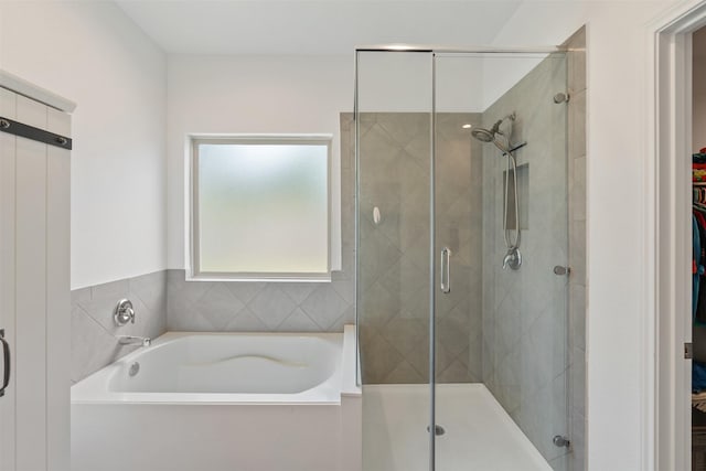 bathroom featuring separate shower and tub