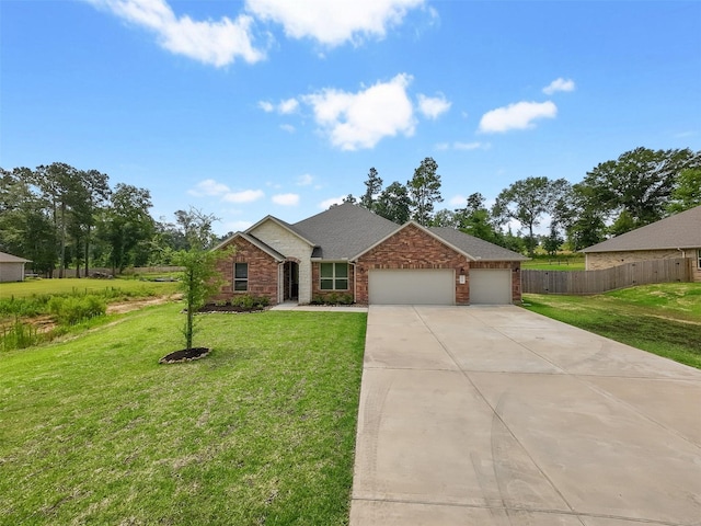 ranch-style home featuring a garage and a front lawn