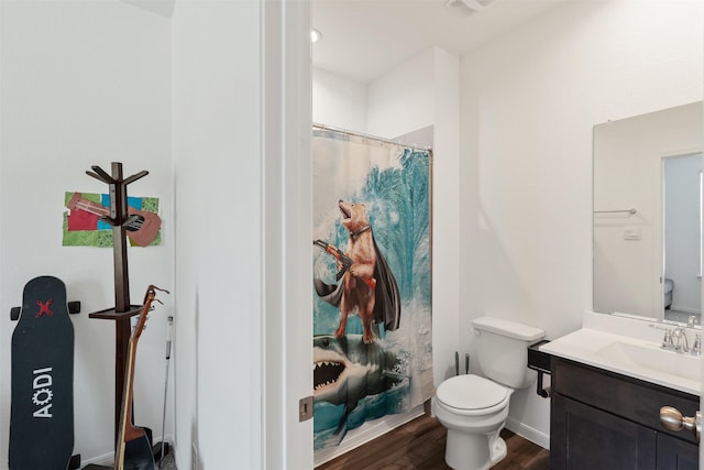 bathroom featuring toilet, a shower with curtain, vanity, and hardwood / wood-style floors