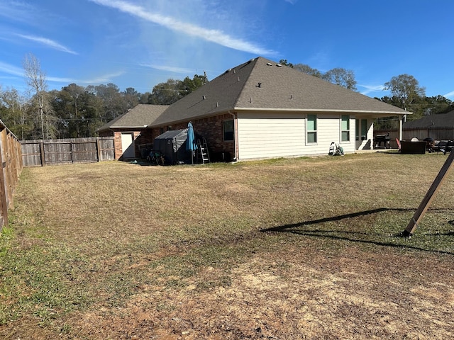 rear view of house featuring a lawn