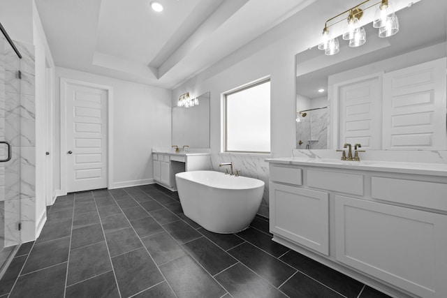 bathroom with tile patterned flooring, vanity, a raised ceiling, and shower with separate bathtub