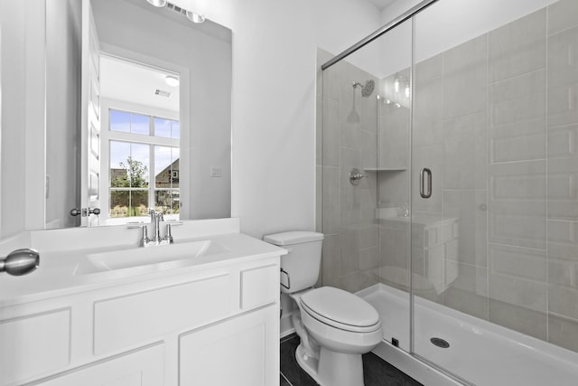 bathroom with vanity, an enclosed shower, and toilet