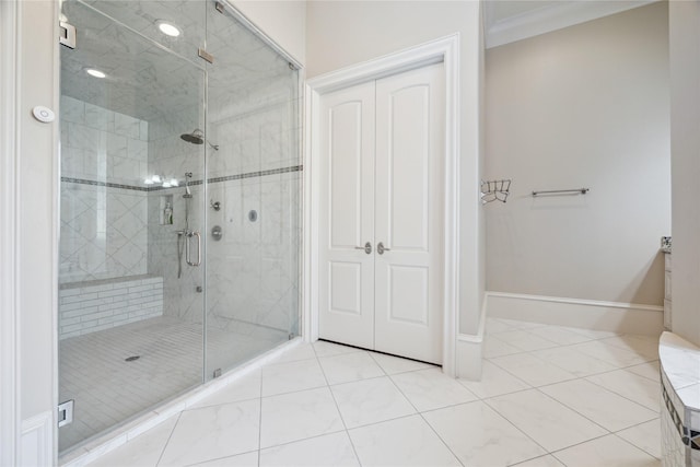 bathroom with vanity, tile patterned flooring, ornamental molding, and walk in shower