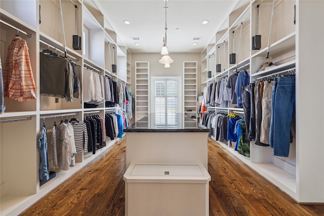 walk in closet featuring dark hardwood / wood-style floors