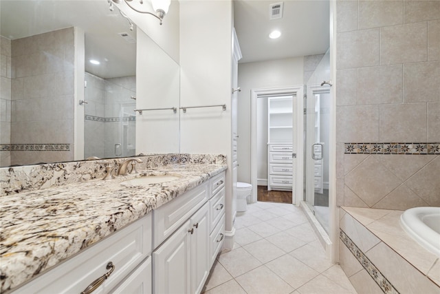 full bathroom with toilet, vanity, tile patterned flooring, and independent shower and bath