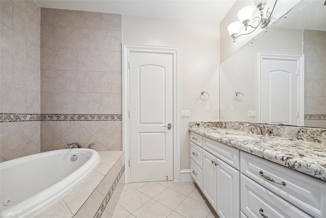 bathroom with tiled bath, tile patterned floors, and vanity