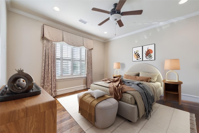 bedroom featuring ceiling fan, ornamental molding, and light wood-type flooring