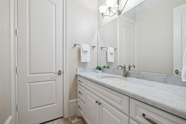 bathroom with an inviting chandelier and vanity