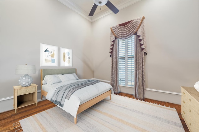 bedroom featuring ceiling fan, dark hardwood / wood-style floors, and ornamental molding