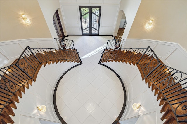 stairs featuring tile patterned floors and french doors