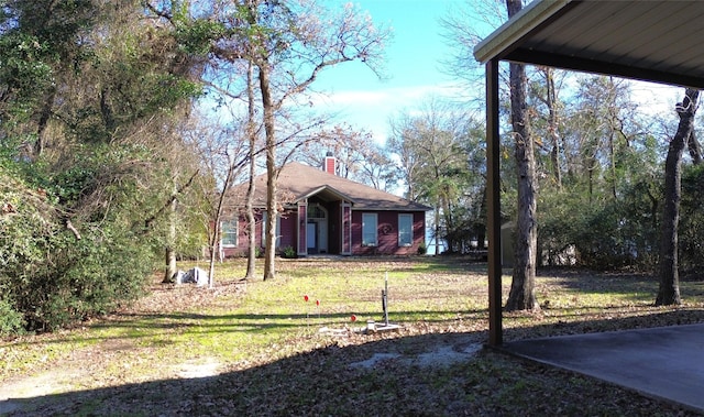 112 Lcr 799a, Groesbeck, TX 76642 - view of front of house with a chimney and a front lawn