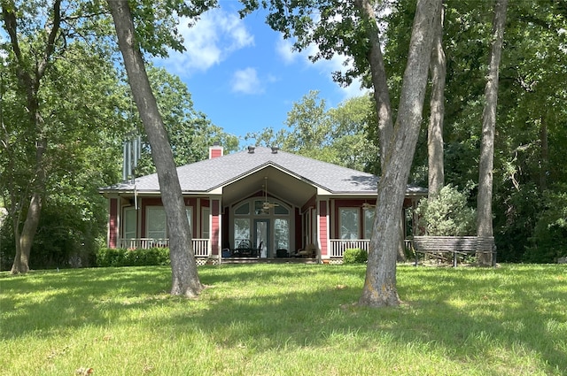 112 Lcr 799a, Groesbeck, TX 76642 - view of front of home with a front lawn, a porch, a chimney, and roof with shingles