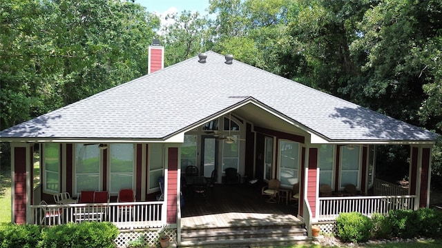 112 Lcr 799a, Groesbeck, TX 76642 - view of front of home featuring a shingled roof, a chimney, a ceiling fan, and a sunroom