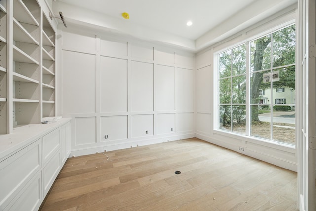 spare room featuring light hardwood / wood-style floors and plenty of natural light