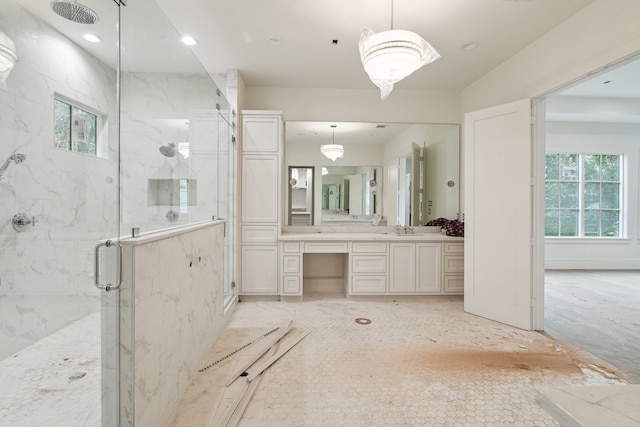 bathroom featuring an enclosed shower and vanity