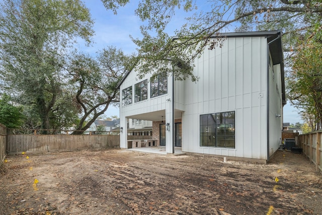 rear view of house with a patio and cooling unit