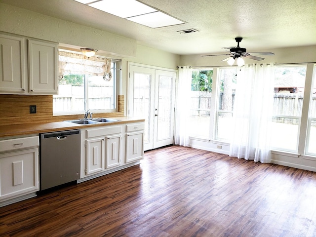 kitchen featuring ceiling fan, sink, stainless steel dishwasher, wood-type flooring, and white cabinets