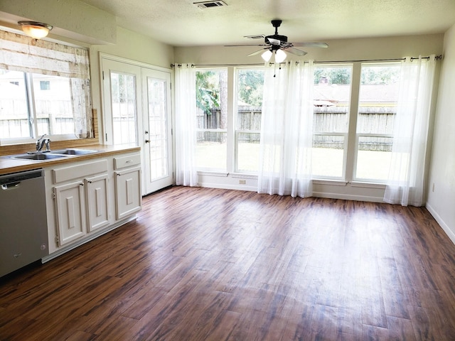 unfurnished sunroom featuring plenty of natural light, ceiling fan, and sink