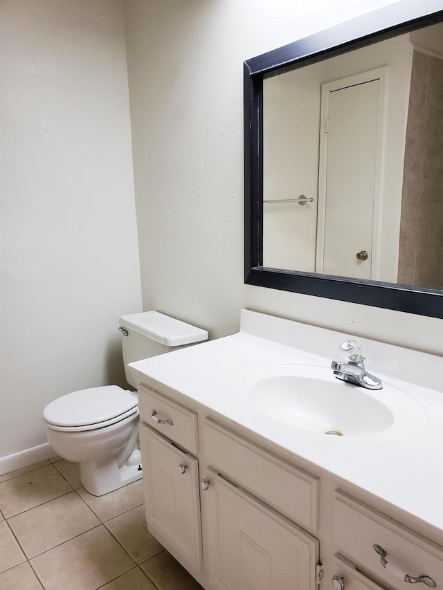 bathroom featuring tile patterned flooring, vanity, and toilet