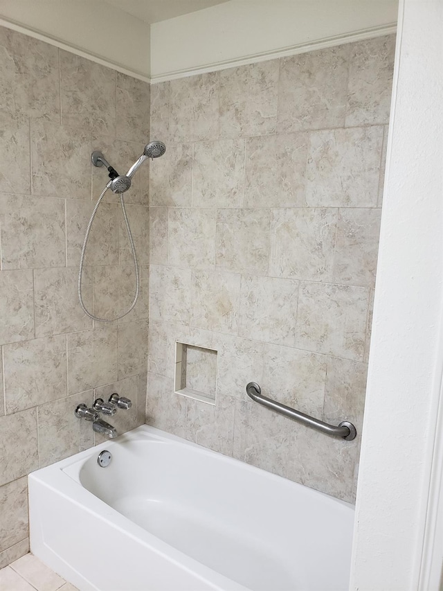 bathroom with tile patterned floors and tiled shower / bath