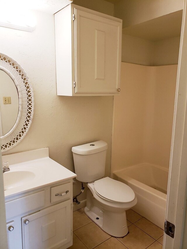 full bathroom with tile patterned flooring, vanity, toilet, and washtub / shower combination