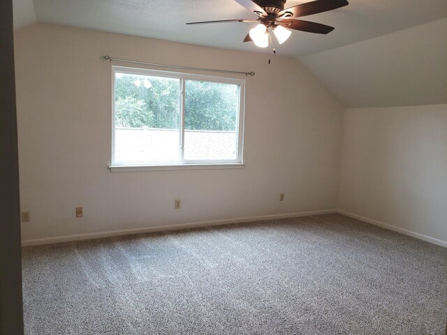 additional living space with carpet flooring, ceiling fan, and lofted ceiling