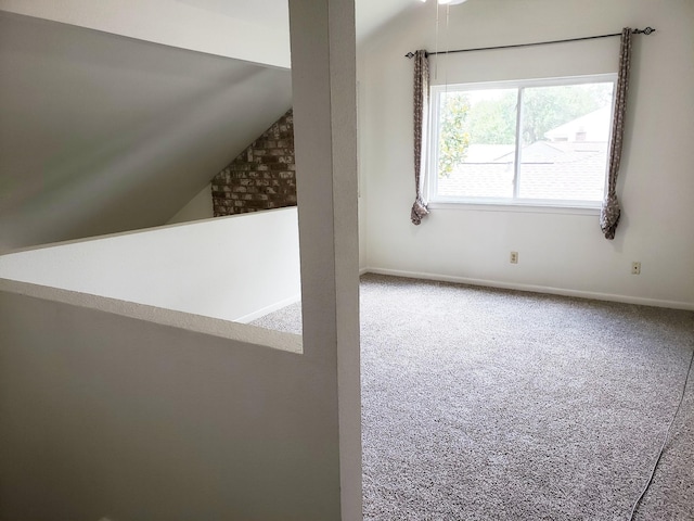 additional living space with carpet flooring and vaulted ceiling